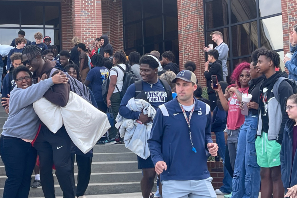 SHS Coach Matt Dobson leads his team for the send off