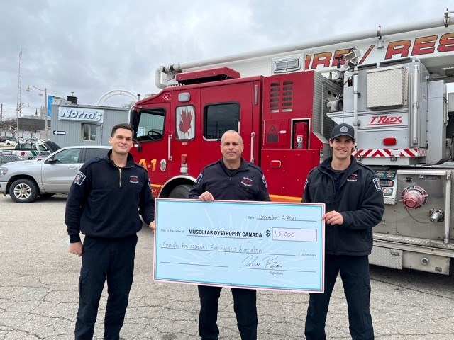 Firefighters Michael Hasson Mike Rao and Jared Bauman hold a cheque for $45,086 for the annual boot toll. 