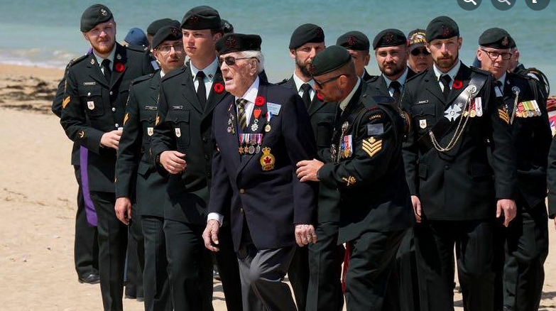 William Seifried at Juno Beach  alongside members of the Royal Regina Rifles.