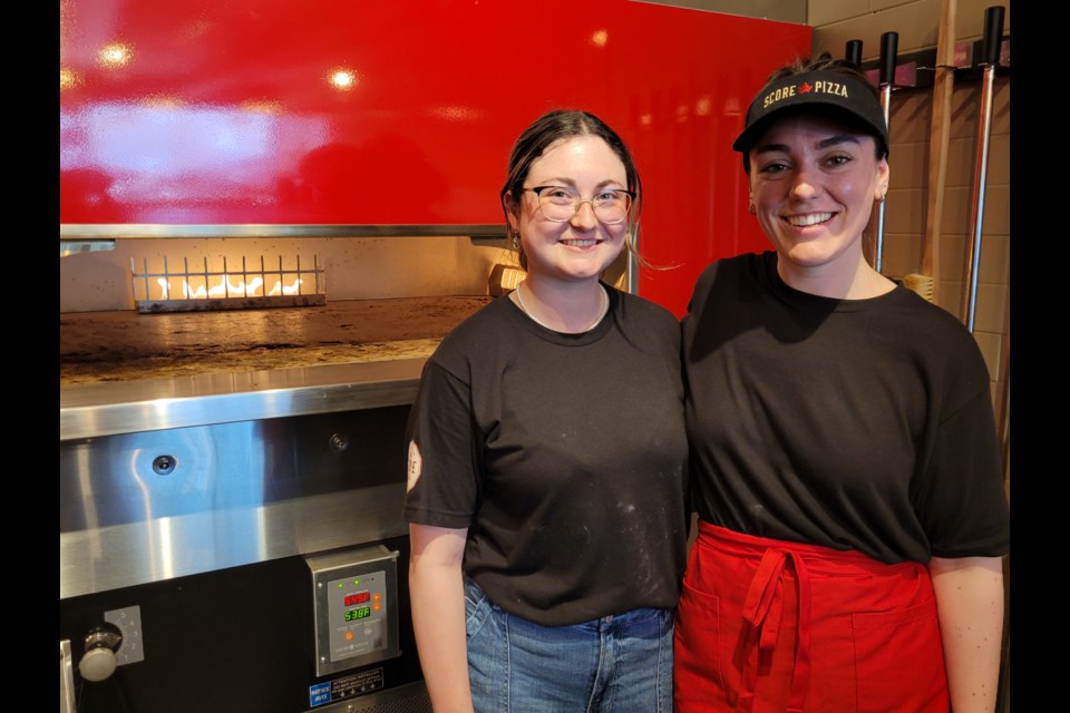 Chloe Zicaro, left, and Genevieve Andre at Score Pizza. 