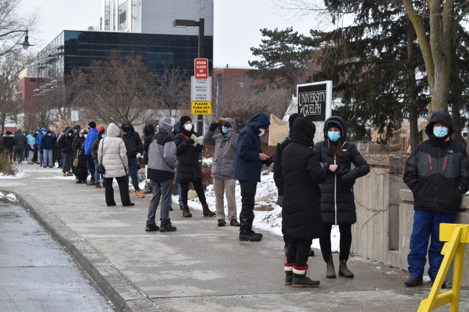 A majority of people waited in line outside of the U of G's University Centre for hours on Monday morning to receive a rapid antigen testing kit.