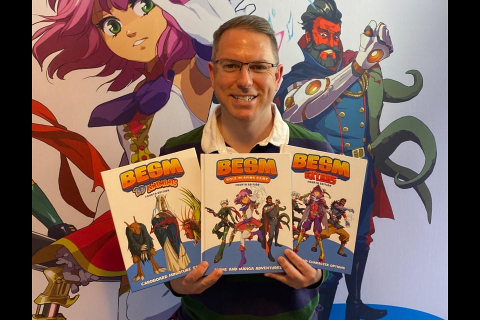 Mark MacKinnon poses with some of the games he's created. Submitted photo.