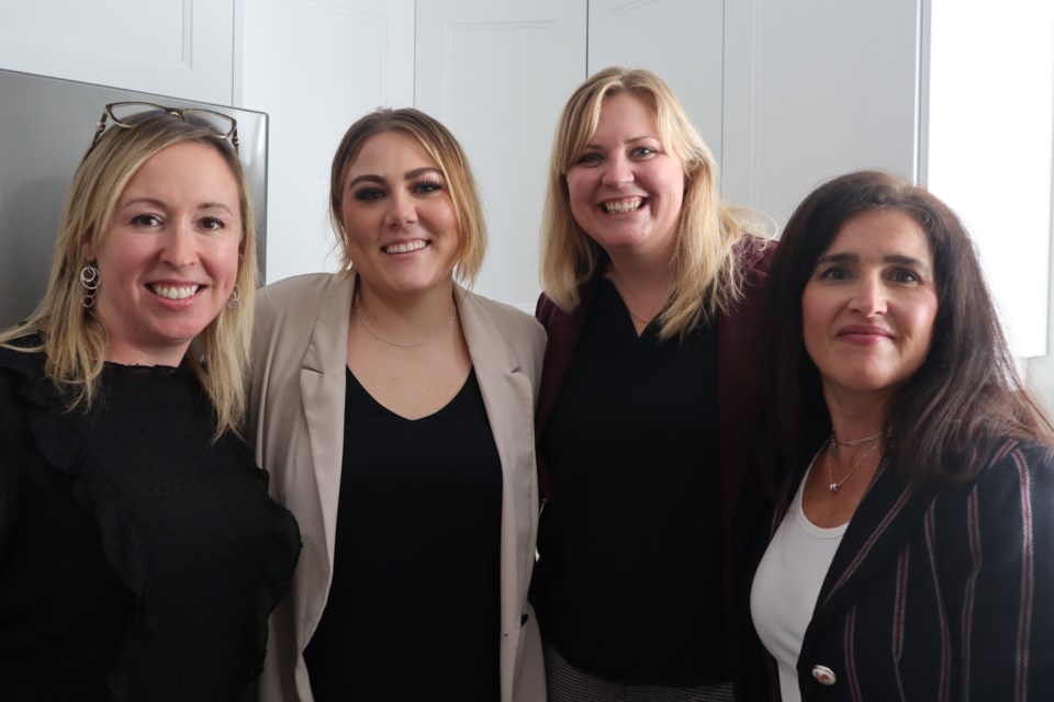 Jamie Edge, Emily Shoemaker, Jessica Johnston and Maria Zegarac, employees at Hopewell, standing in the renovated kitchen in their newest home to support people with developmental disabilities.