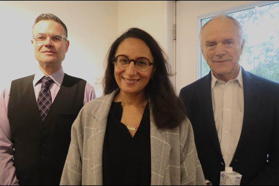 Damian Weston, Madhur Anand, and Nicholas Ruddock inside Rivermead, the Eden Mills Writers' Festival headquarters.