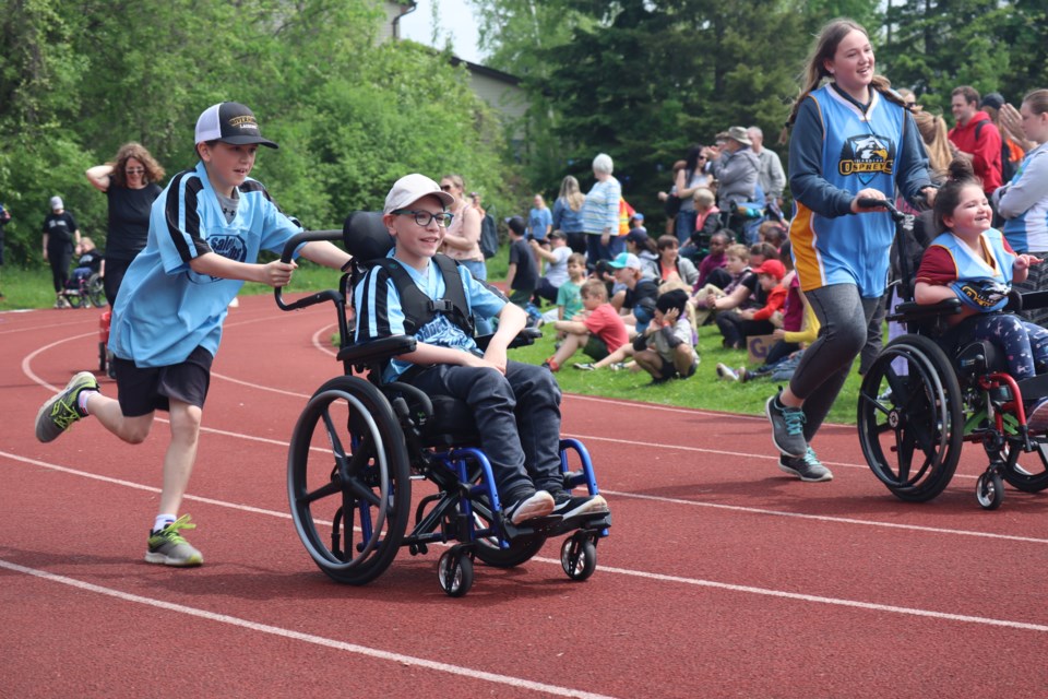 Athletes happy to make it to the end of the race while the crowd cheers them on at the local school boards' Special Olympics Wednesday at St. James high school. There were 878 athletes in Grade 2 to 12 from UGDSB and WCDSB schools who participated. 