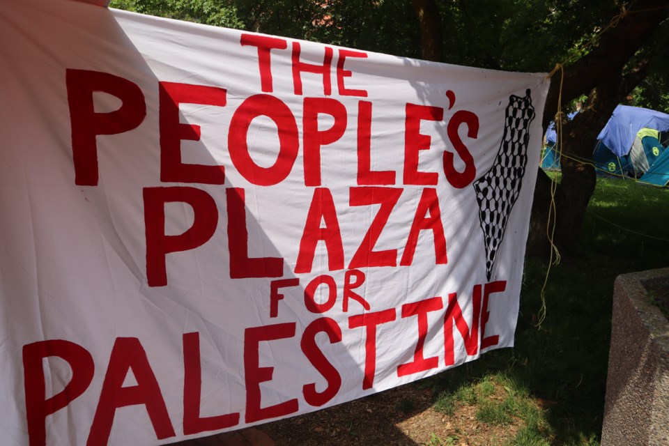 At the entry point of the encampment a sign reads "The People's Plaza for Palestine."