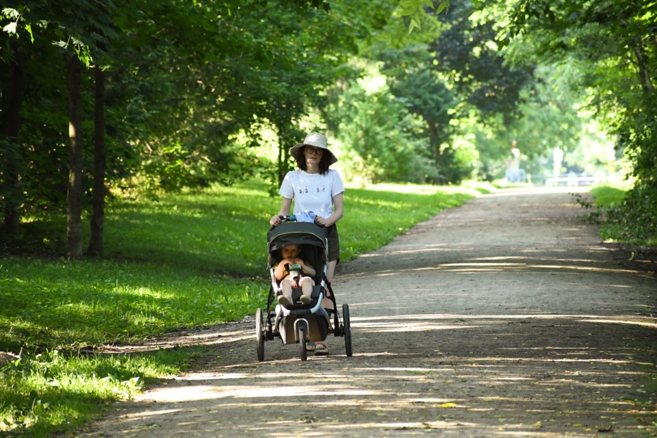 Jocelyne Fletcher takes a stroll with her daughter, Matilda, along the CNR Spurline Trail.