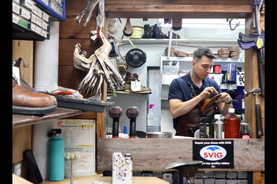 Pablo Hadarits, owner of Dimar Shoe Repair at 15 Quebec St. taking stitching out of a shoe.