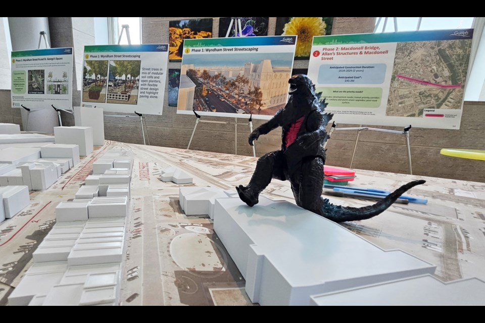 A Godzilla toy was placed on a model of downtown displayed during an open house at city hall on Wednesday.