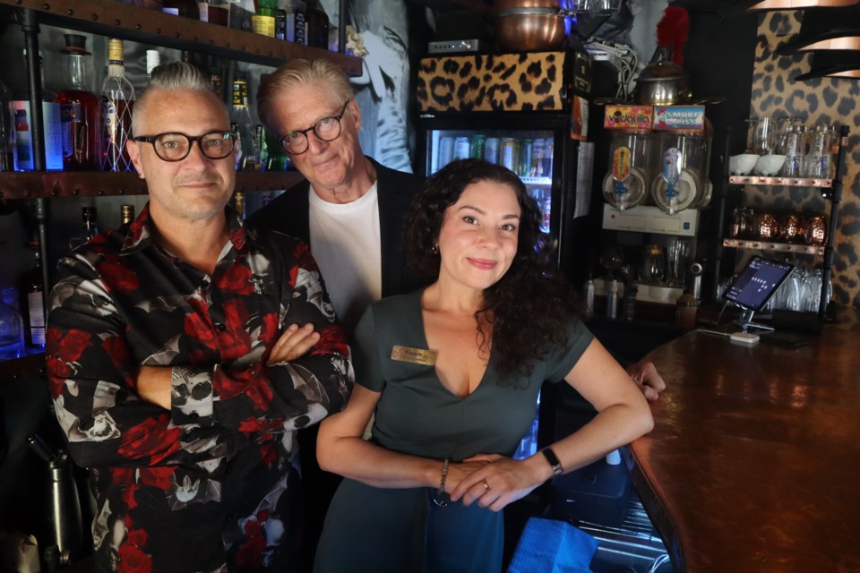 Standing Room Only bar owner Doug Todd and actors Kim Lombard and Caroline Concordia behind the bar a day after shooting the movie Super Retired.