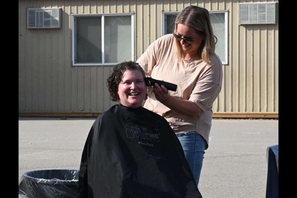 Pam Pegelo, teacher at St. Joseph Catholic Elementary School in Fergus, getting her head shaved by Amber O'Rourke, parent and hairdresser in Fergus.