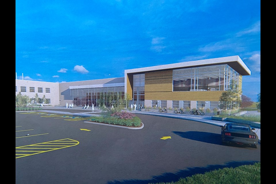 Photo of a printed copy of one of the renderings of the new Guelph high school designed by Hossak Architecture.