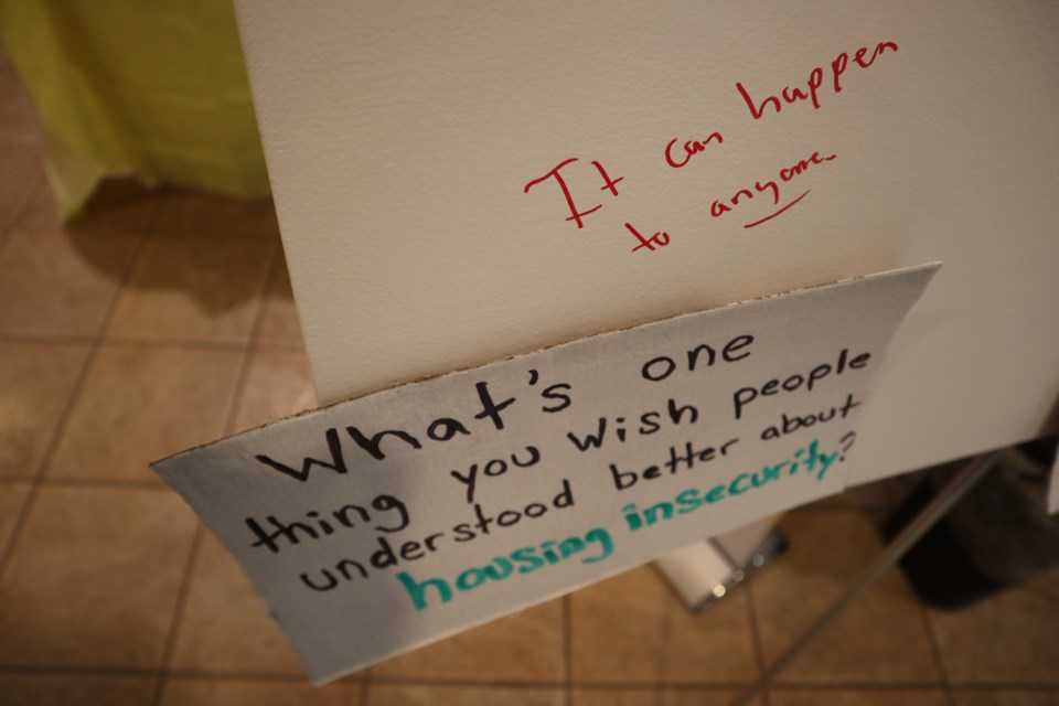 Poster board with prompts asking people what they wished people could better understand about housing insecurity and someone wrote that it can happen to anyone.