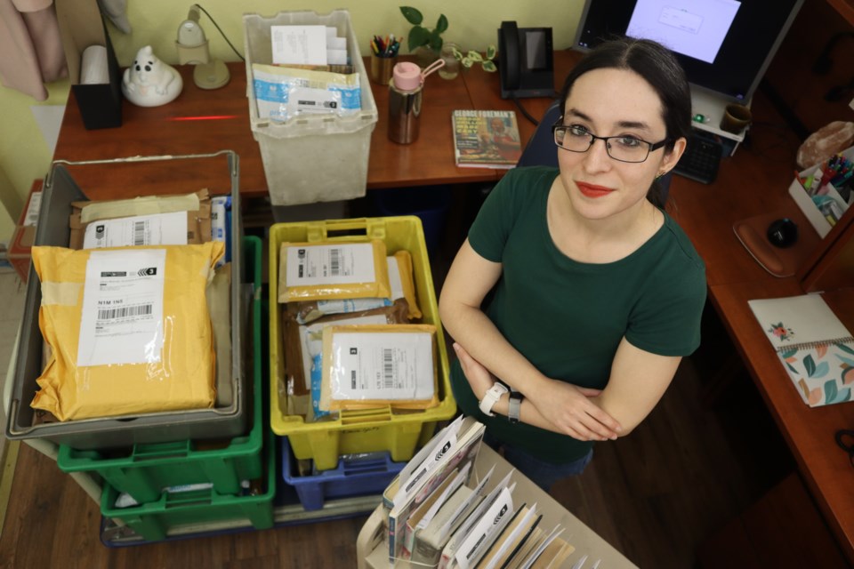 Tina Nickson, library assistant and interlibrary loans at the Guelph Public Library surrounded by book packages unable to be sent to local branches and elsewhere due to the Canada Post strike.