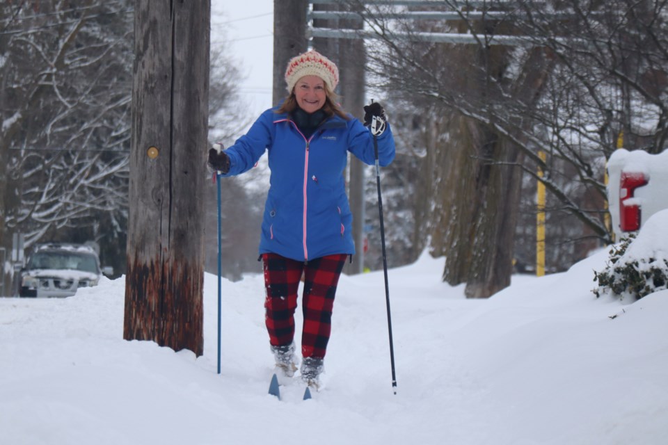 A woman goes cross-country skiing on Palmer Street Thursday morning after a winter storm left a hefty dump of snow.