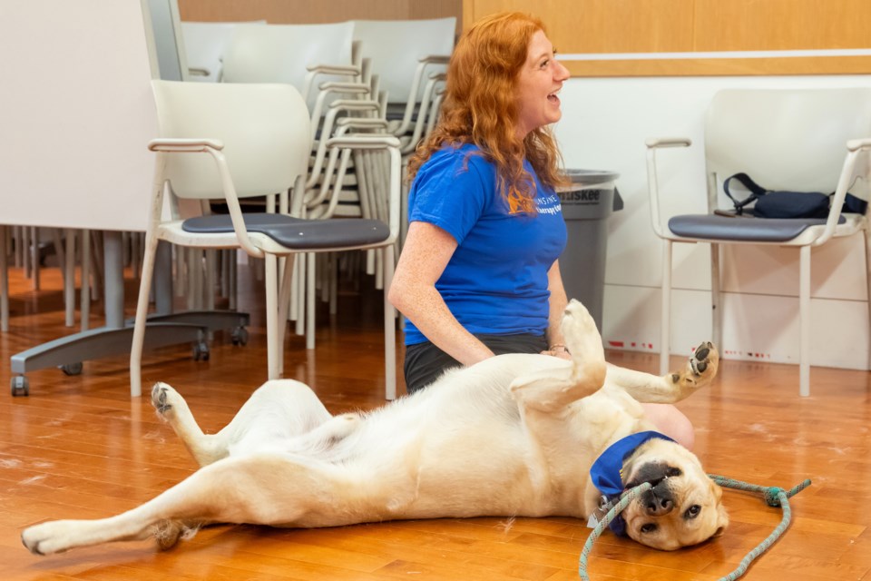 Volunteer Shara Birnbaum with her dog Carter at an employee wellness visit in Toronto.