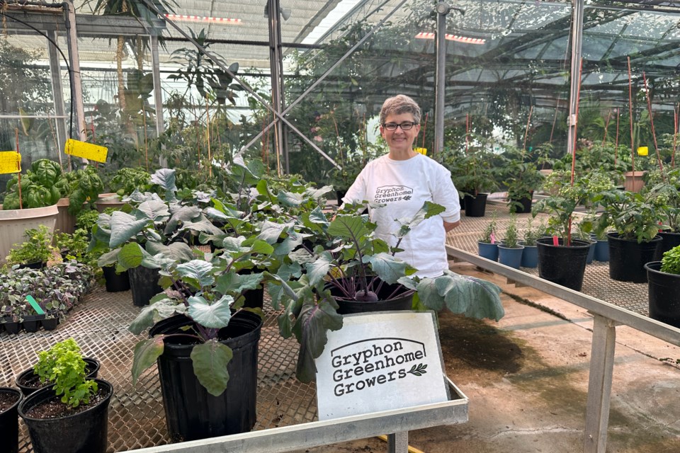 Charlene Winchcombe-Forhan beside the Gryphon Greenhome Growers section of the University of Guelph's Bovey Teaching Greenhouse.