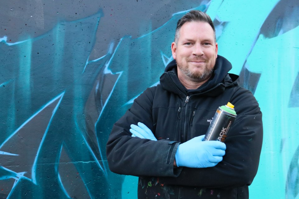 Around 25 artists got together Saturday to beautify the wall along the trail behind 27 Cardigan St.