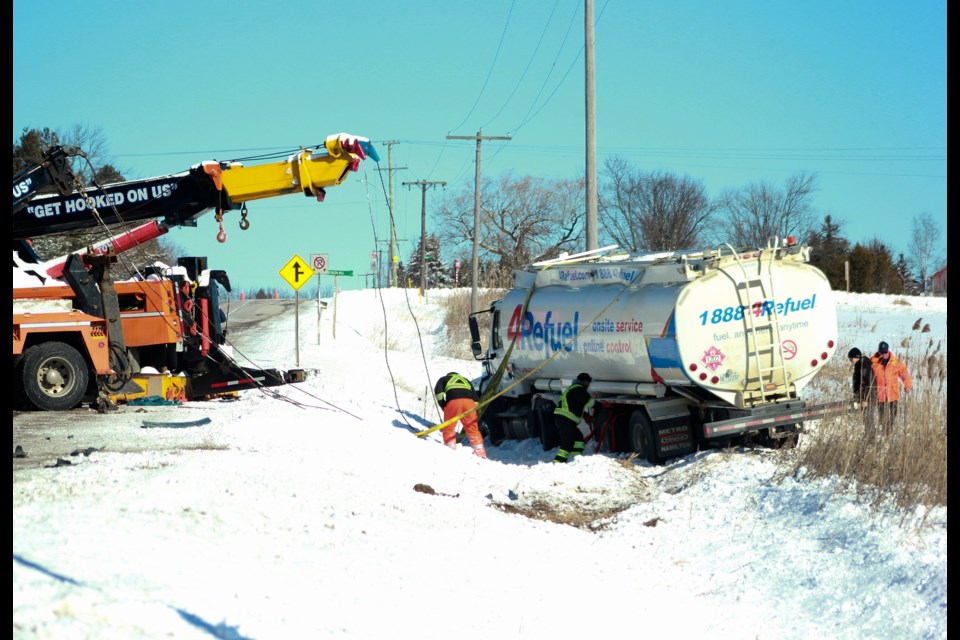 Crews work at pulling a fuel truck out of a ditch on County Road 124 just east of Guelph Monday morning. Tony Saxon/GuelphToday