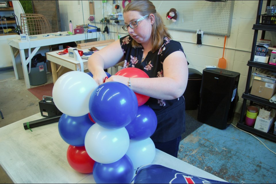 Jessi Morin makes an air-filled decoration at Looney Ballooney.