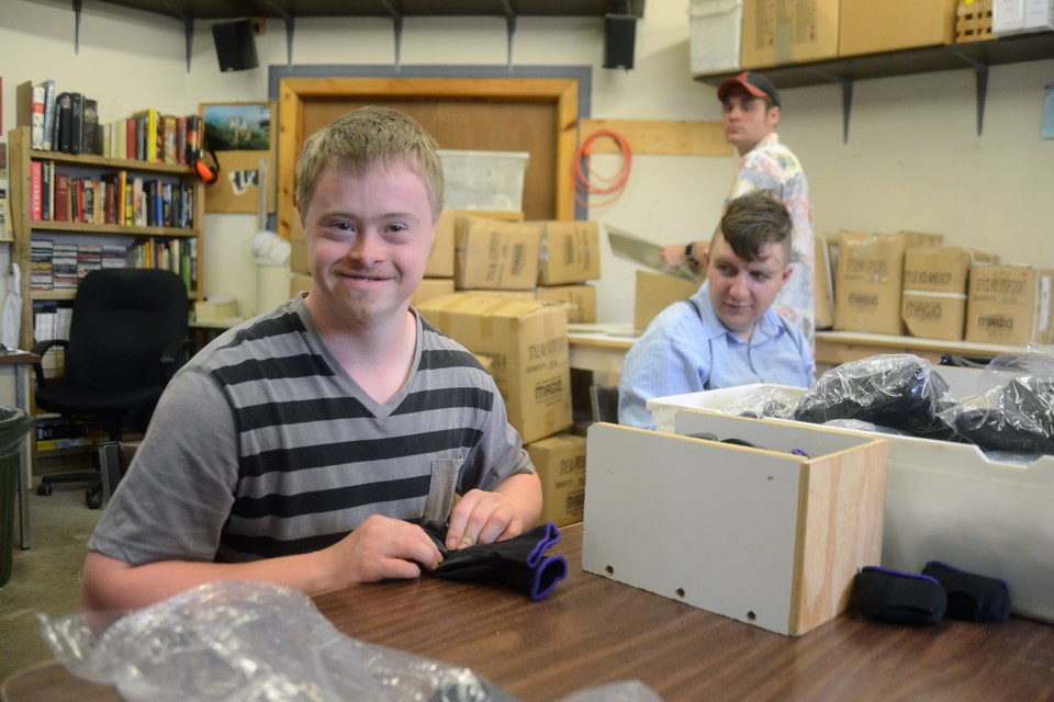 Torchlight clients work at packaging gloves. Tony Saxon/GuelphToday