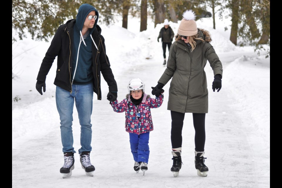 Some helping hands on the Riverside Park Ice Trail on Sunday. The trail has lights for night skating. Tony Saxon/GuelphToday