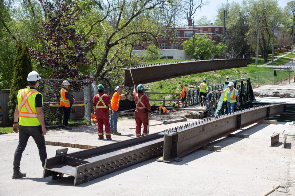 One of three new trusses for the Norwich Street Bridge is moved into position on Monday. Construction of the new footbridge is expected to be completed in mid-July. Kenneth Armstrong/GuelphToday