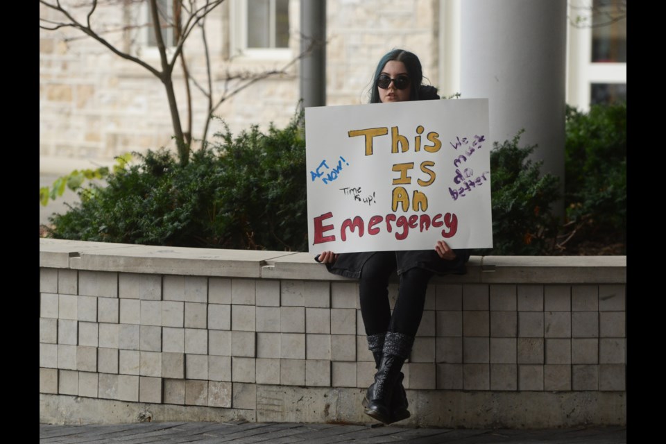 A young person waits for the Keeping Our Friends Warm Rally to begin. Tony Saxon/GuelphToday