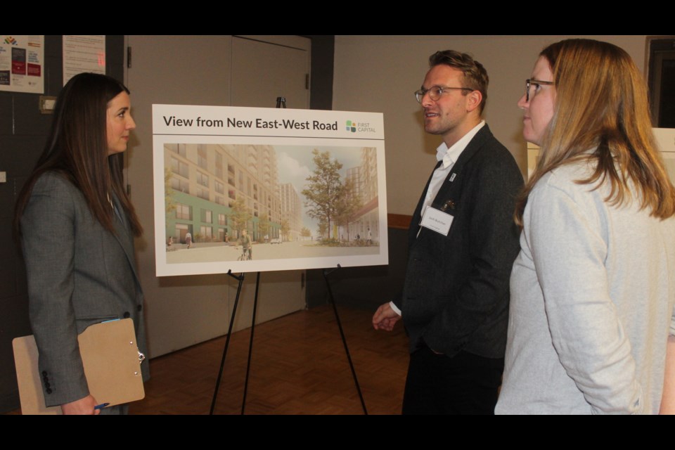 Joshua Butcher of First Capital shows off a rendered image of a reimagined Pergola Commons at an open house Tuesday.