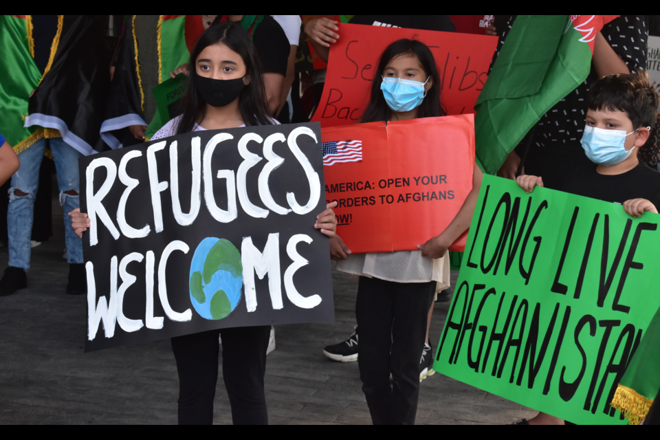 Children hold signs.