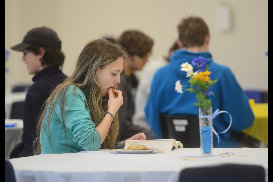 A student studies while enjoying the benefits of the Food & Friends program in the John F. Ross cafeteria Friday, March 2, 2018. Tony Saxon/GuelphToday