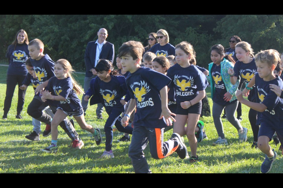 Students at St. Francis of Assisi Catholic School set off on a run in memory of teacher Sean MacMillan.