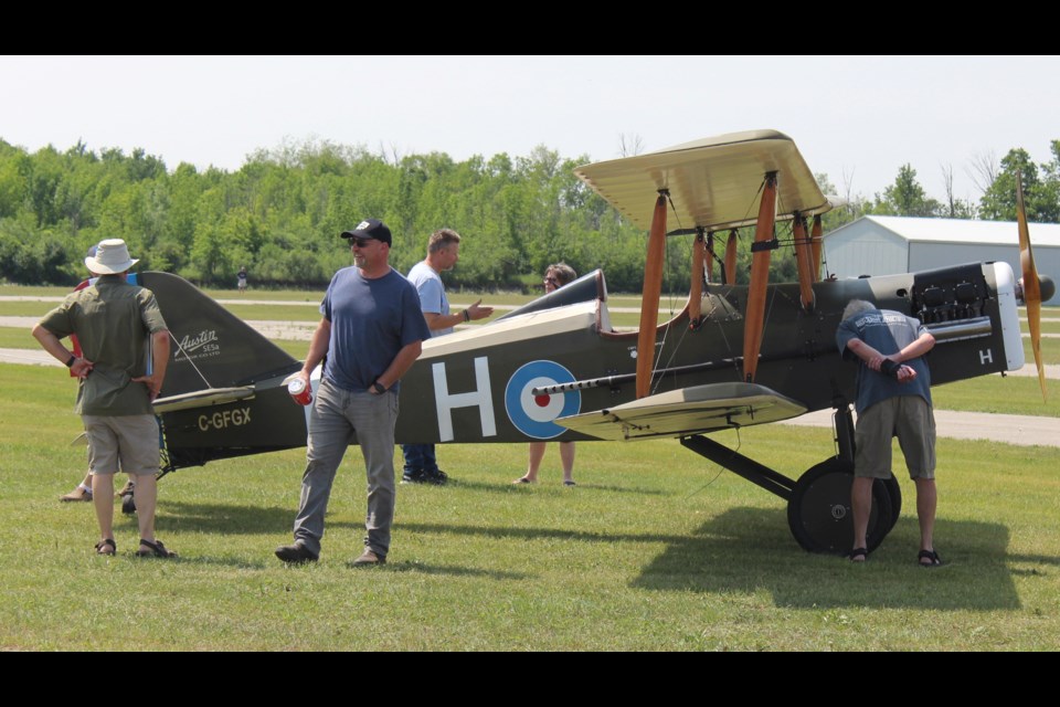 Checking out a classic plane as many took in the sights at the Shiny Side Up Rendezvous at the Guelph AirPark Sunday, in support of Canadian Owners and Pilots Association for Kids.