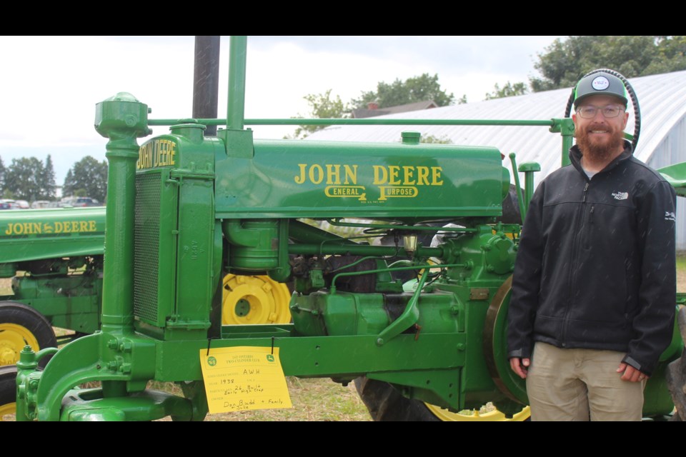 Chris Budd, the president of the First Ontario Two-Cylinder Club, and his John Deere tractor, circa 1938.