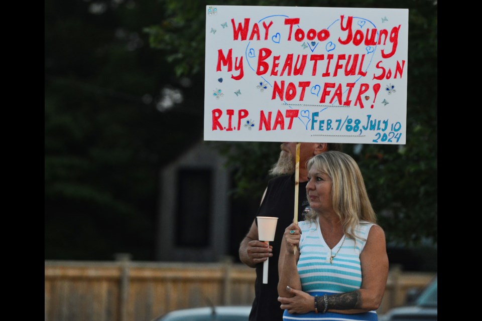 Faye Dzikewich, the mother of Nathaniel Schofield, stands at the side of the road in Rockwood Sunday evening across the street from the Rockwood OPP station where her son died while in police custody. 