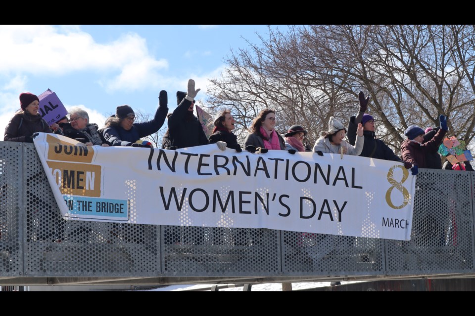 About 20 people turned up on the Veterans Memorial Bridge to kick off International Women's Day celebrations Saturday in Guelph.