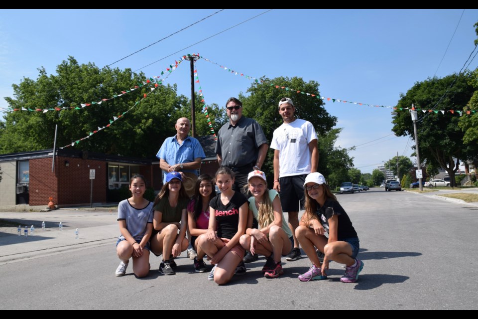 Italian Canadian Club president Stephen Gazzola, back row, middle,  with festival helpers on Ferguson Street. Come Friday, the street will be packed with visitors to Festival Italiano. (Rob O'Flanagan/GuelphToday)