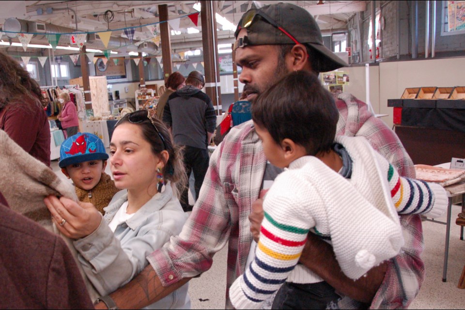 The first Sunday Special Antique Market was held at Guelph Farmers' Market this past weekend. Seen here, the Dabideen family – parents Diane and Nicholas, with two-year-old Sage and 10-month-old Amari – checks out a used jacket. 