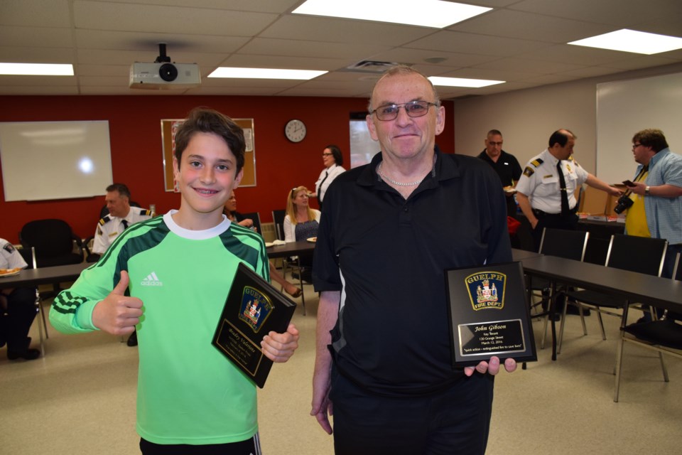 Brady Valeriote, left, and John Gibson were honoured by the Guelph Fire Department this week for their fire safety measures. 