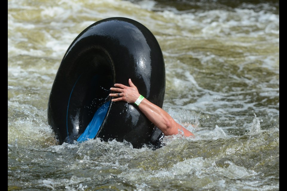 A tuber gets momentarily upended as she starts her trip down the Grand River on a sold-out tubing day at the Elora Gorge Conservation Area on Saturday. Tony Saxon/GuelphToday