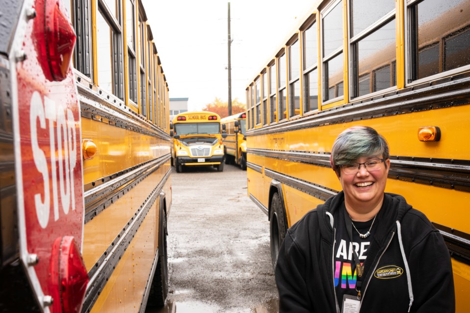 Jonah Wainberg poses outside of her bus at the Switzer-Carty Transportation lot. Wainberg has decorated her bus, which she says keeps kids safe while they have fun. Kenneth Armstrong/GuelphToday