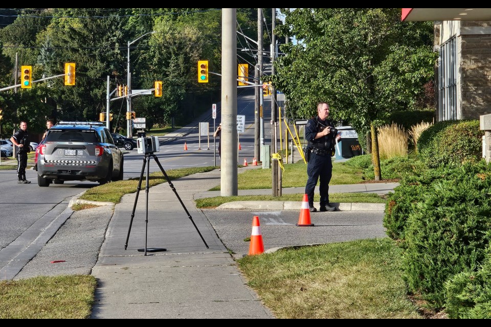 Police investigate the scene on Eramosa Road at the Shoppers Drug Mart parking lot where a pedestrian was hit and killed Thursday afternoon.