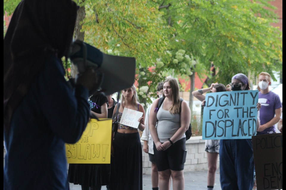 Dozens of people gathered outside Guelph City Hall Wednesday to protest the discussion of a public space bylaw.