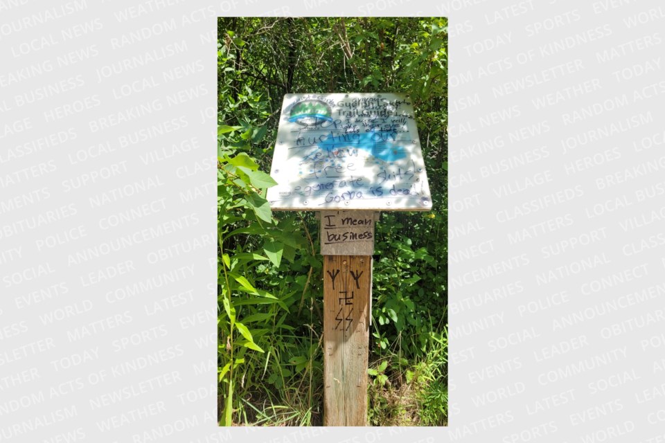 One of the signs defaced along the Guelph Lake Trail. GORBA, the organization tasked with maintaining the trail system near Guelph Lake, are expressing concern, as multiple messages have turned up.