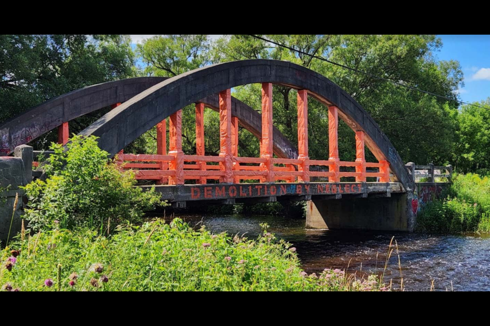 Street artist Lionel wrapped much of McQuillan's Bridge in orange fabric for a work known as 'Demolition by Neglect.'