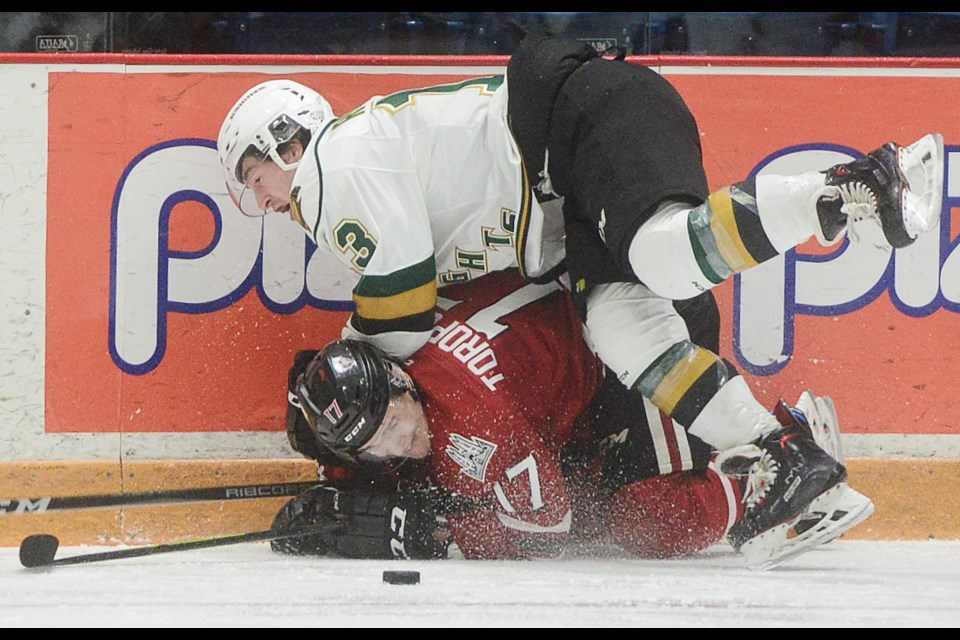 Tyler Rollo of the London Knights buries the Guelph Storm's Alexey Toropchenko with a check Sunday at the Sleeman Centre. Tony Saxon/GuelphToday