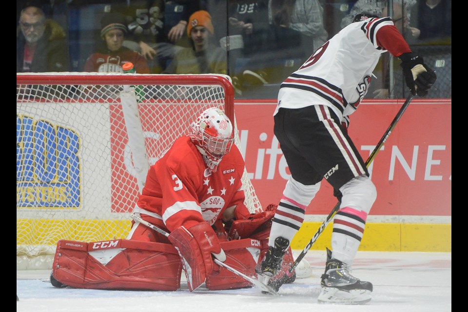 Matthew Villalta of the Soo Greyhounds stops the Guelph Storm's Isaac Ratcliffe in close. Tony Saxon/Village Media