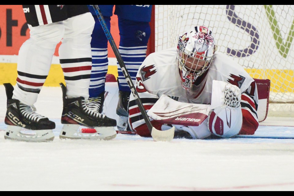 Guelph Storm netminder Brayden Gillespie covers up the puck in his crease.