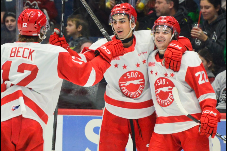 Soo Greyhounds players celebrate a first period goal.