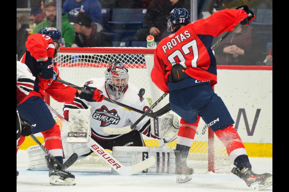 Windsor's Ilya Protas swats a loose puck out of the air to give the Spitfires a 1-0 lead Friday at the Sleeman Centre.